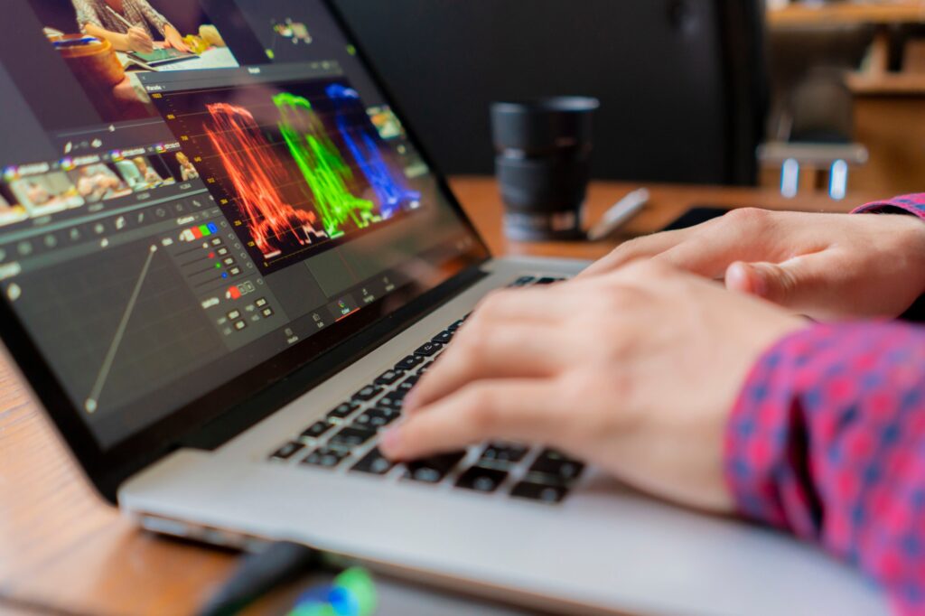 male producer edit video on his laptop in studio b